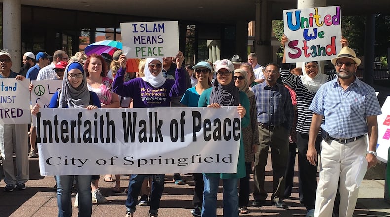 Members of the Miami Valley Islamic Association of Springfield participate in a peace walk in downtown Springfield.