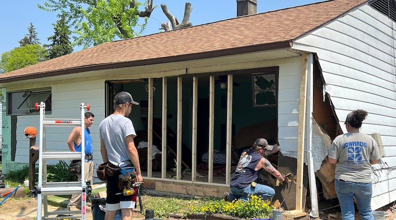 Contractors work on a Springfield home near Horace Mann Elementary School Wednesday afternoon after the house was significantly damaged earlier that morning when a car drove into the front of it. The owner of the home Cheryl Anon says she was asleep in the living room when a car crashed through. Anon did not suffer any injuries, but said that the driver had backed out of the house and drove away from the property. Police are investigating the incident and one person was taken into custody. Hasan Karim/Staff