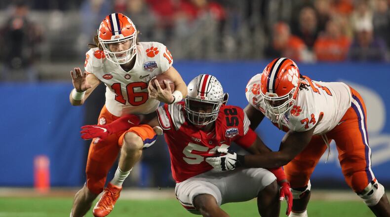 GLENDALE, ARIZONA - DECEMBER 28: Quarterback Trevor Lawrence #16 of the Clemson Tigers scrambles with the football during the PlayStation Fiesta Bowl against the Ohio State Buckeyes at State Farm Stadium on December 28, 2019 in Glendale, Arizona. The Tigers defeated the Buckeyes 29-23. (Photo by Christian Petersen/Getty Images)