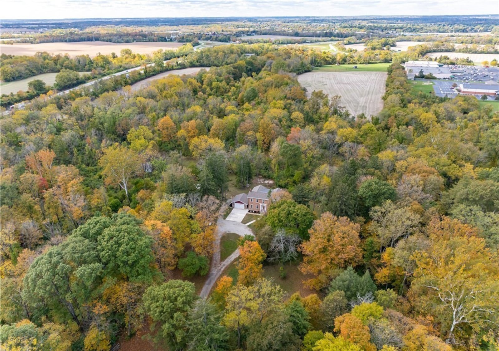 The home sits on 48 wooded acres and includes an outdoor pavilion with fireplace, a barn and walking trails. CONTRIBUTED