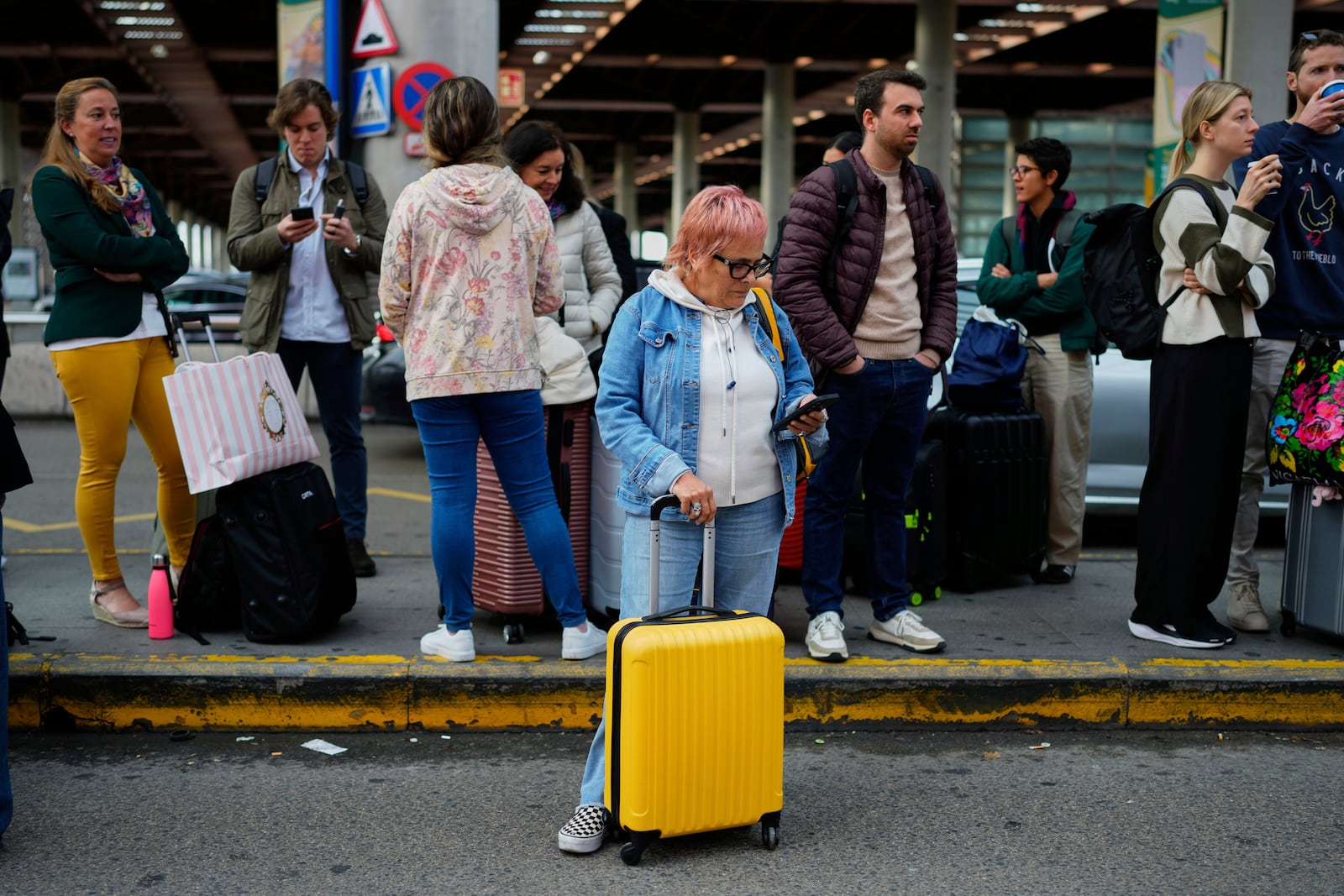 Travelers wait for news about their delayed trains at the Madrid train station, Spain, Monday, May 5, 2025. (AP Photo/Manu Fernandez)