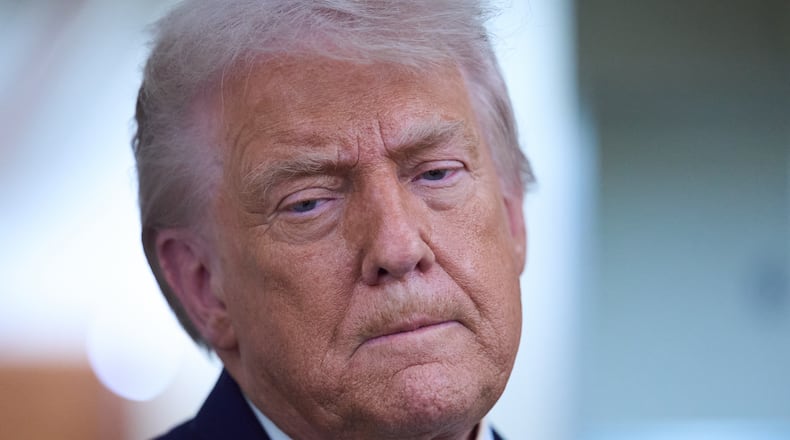 President Donald Trump speaks with reporters aboard Air Force One after leaving the World Economic Forum in Davos for Washington, Thursday, Jan. 22, 2026. (AP Photo/Evan Vucci)