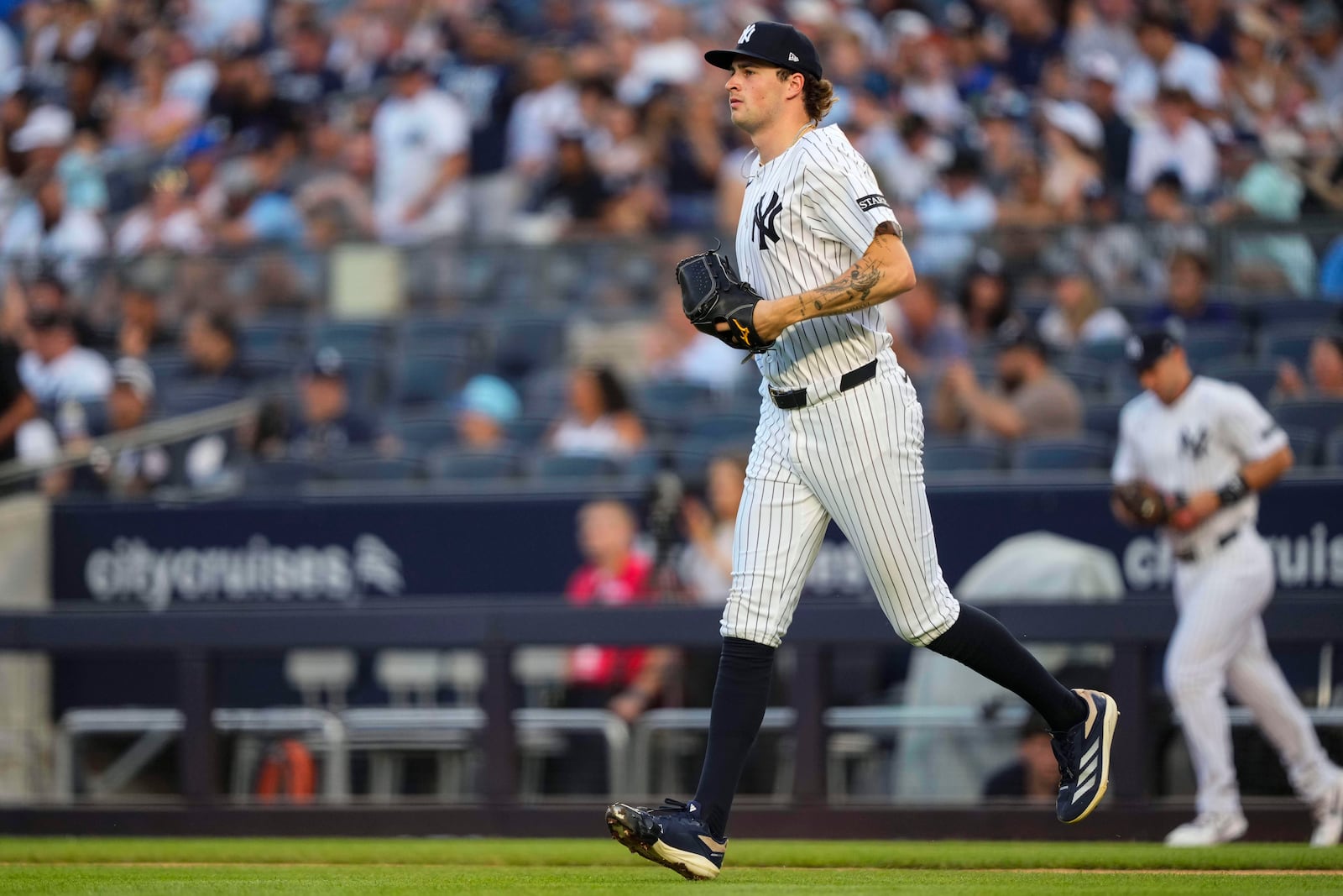 New York Yankees pitcher Cam Schlittler (31) walks onto the field during the first inning of a baseball game against the Seattle Mariners, Wednesday, July 9, 2025, in New York. (AP Photo/Yuki Iwamura)