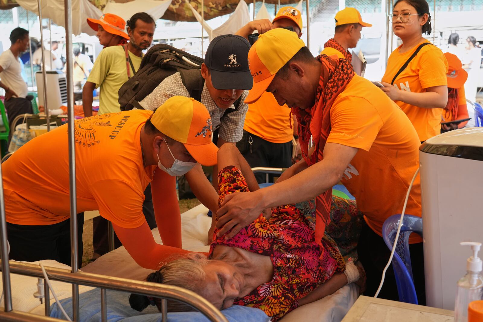 Bhutan medical volunteers give treatments to a patient at their make-shift tent after last week's earthquake in Naypyitaw, Myanmar, Friday, April 4, 2025. (AP Photo)