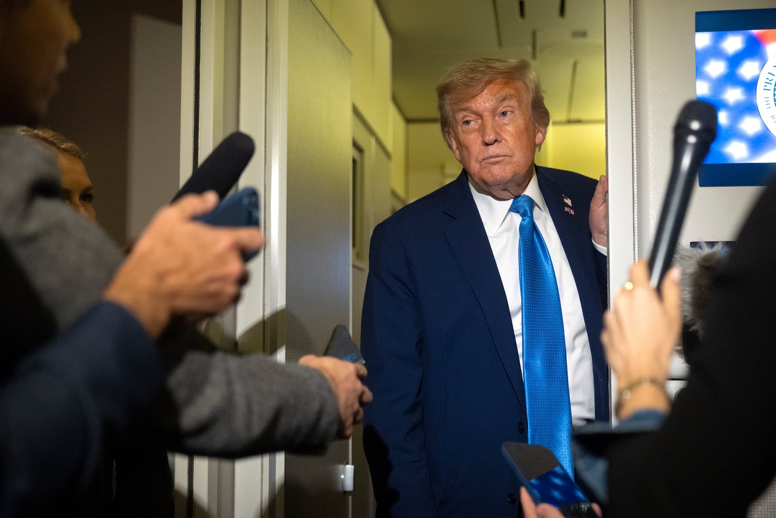 President Donald Trump speaks with reporters while flying aboard Air Force One en route from Calgary, Canada to Joint Base Andrews, Md., late Monday, June 16, 2025. (AP Photo/Mark Schiefelbein)