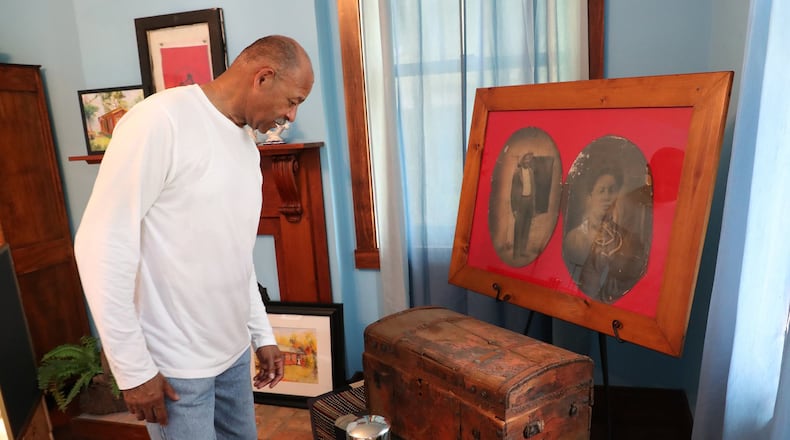 Dale Henry, president of Gammon House, Inc., looks over a trunk and pictures that belonged to Addison White, a runaway slave who’s freedom was purchased by the residents of Mechanicburg in 1857, on display in the Gammon House for the Juneteenth and Fatherfest Celebrations a few years ago. Bill Lackey/Staff