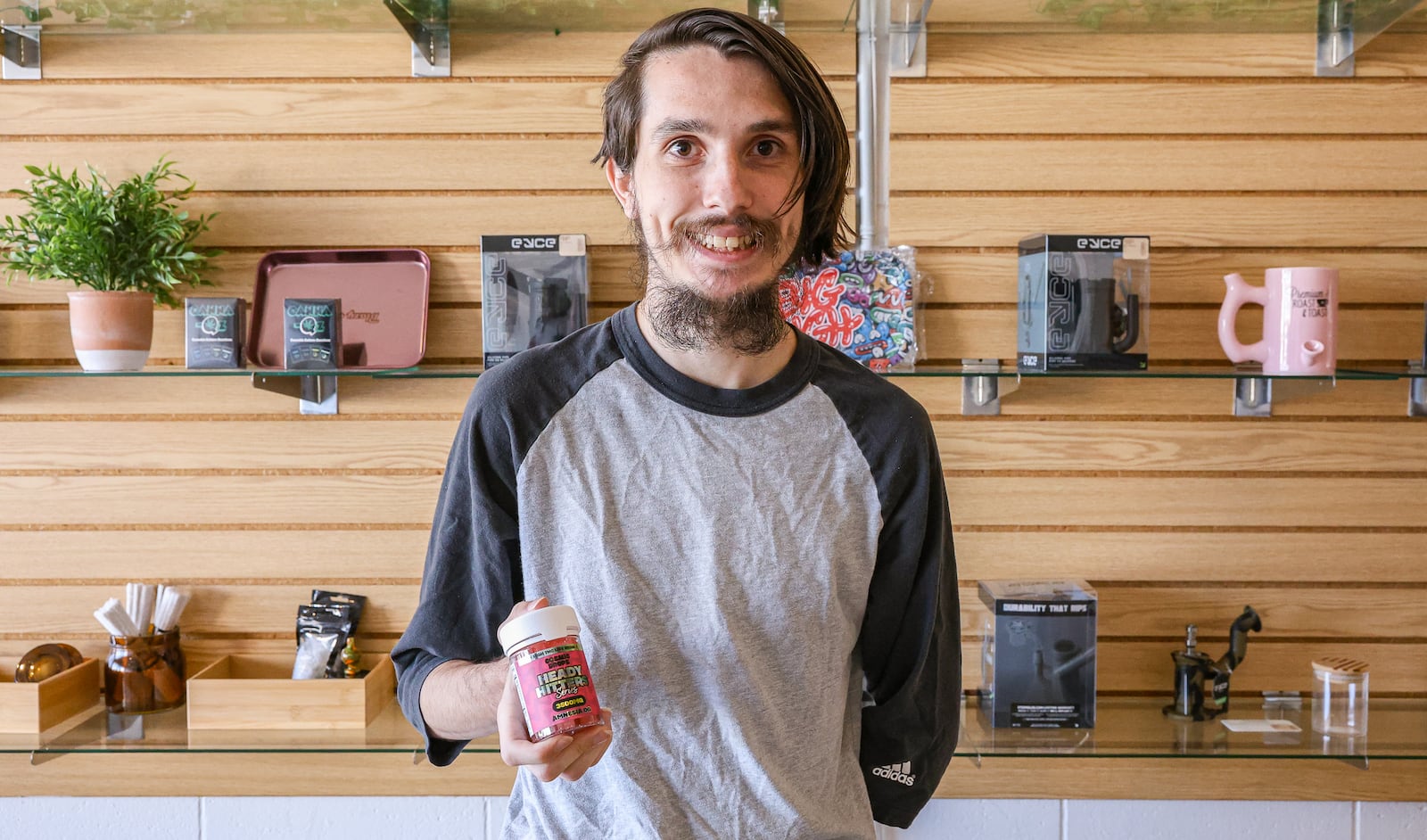 Vapor Haus manager Troy Grant with gummy drops, Thursday, Oct. 9. Grant said that intoxicating hemp products should not be sold to anyone under 21. Vapor Haus does not allow anyone under 21 to enter the store. BRYANT BILLING / STAFF