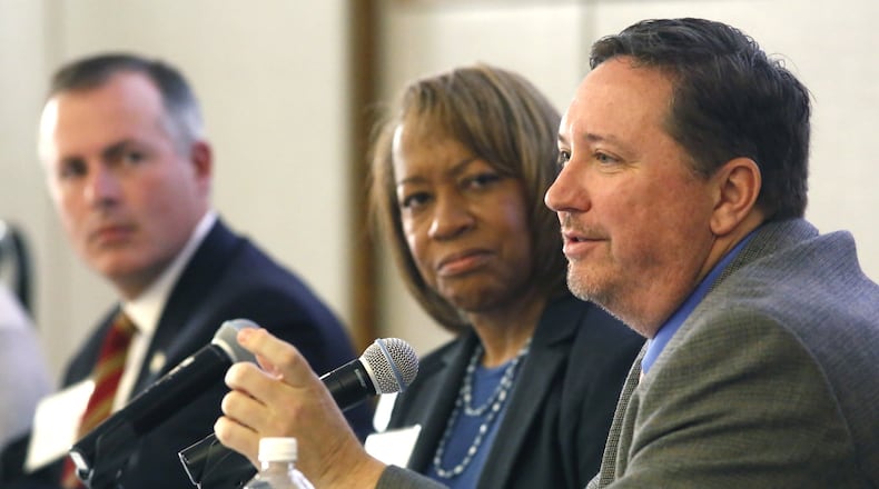State Representative Robert Sprague, left, and Helen Jones-Kelley, executive director of the Alcohol, Drug Addiction and Mental Health Services for Montgomery County, listen as State Representative Jeff Rezabek makes a point about the opioid crisis during a recent Impact Ohio panel discussion. TY GREENLEES / STAFF