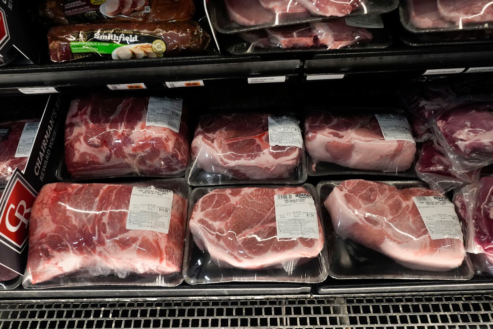 FILE - Pork products line the cooler at a grocery store in New Orleans, April 17, 2024. (AP Photo/Gerald Herbert, File)