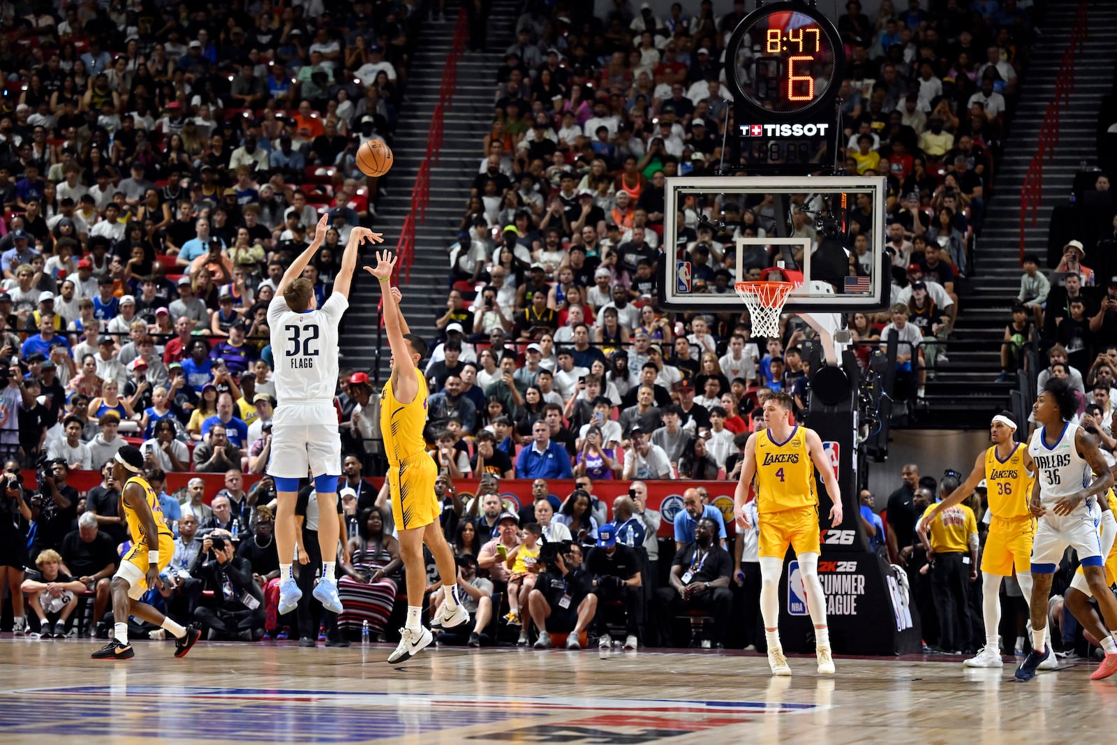 Dallas Mavericks forward Cooper Flagg (32) attempts a three-point basket against the Los Angeles Lakers during the first half of an NBA summer league basketball game Thursday, July 10, 2025, in Las Vegas. (AP Photo/David Becker)
