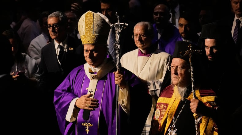 Pope Leo XIV arrives with Ecumenical Patriarch Bartholomew I, the spiritual leader of the world's Eastern Orthodox Christians to celebrate a Mass at the Volkswagen Arena, in Istanbul, Turkey, Saturday, Nov. 29, 2025. (AP Photo/Khalil Hamra)