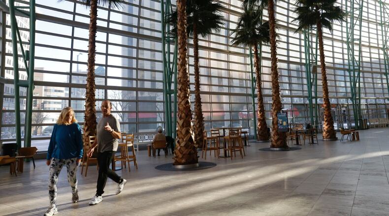 Rick and Cheryl Carne of Dayton walk around for exercise Tuesday, Jan. 16, 2024, inside the Schuster Performing Arts Center. Outside, the temperature was in the teens in downtown Dayton. JIM NOELKER/STAFF