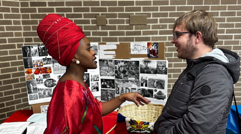AJ Auguste (left), a first year student at Clark State, explains a Haitian cooking stove to fellow first year student Griffin Sweeney (left) at the third annual Culture Fest hosted by the college this week. Auguste has been in Springfield for several years and is studying political science at Clark State. CONTRIBUTED