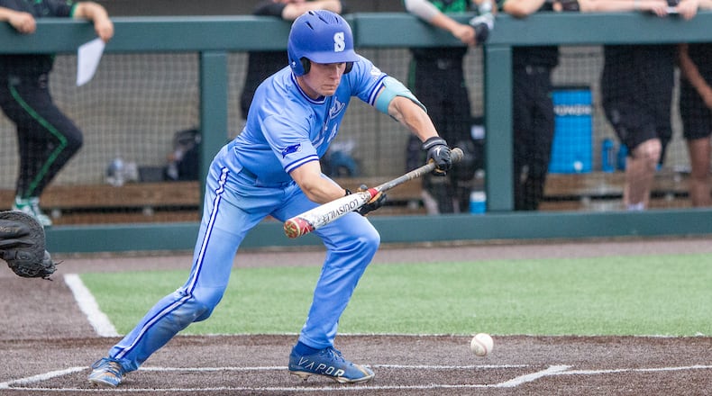 Springboro's Vince Fortkamp bunts for a single that scored Adam Smith for a 2-1 lead in the fourth inning in Thursday's Division I regional final. Jeff Gilbert/CONTRIBUTED
