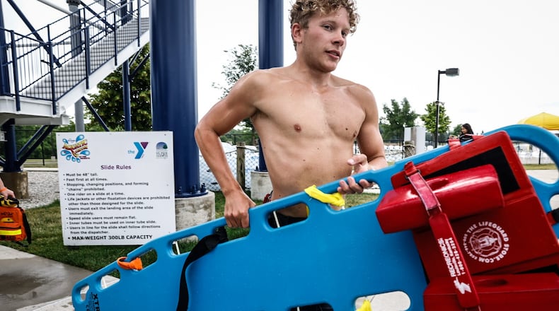 Head lifeguard at the Kroger Aquatic Center in Huber Heights, Tyler Gould goes through training exercises before the pool opens Friday June 23, 2023. JIM NOELKER/STAFF
