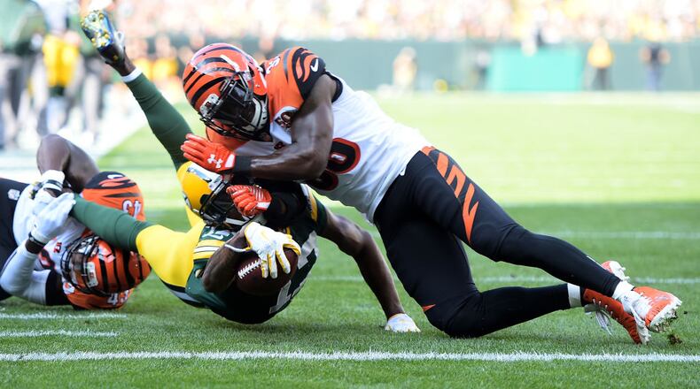 GREEN BAY, WI - SEPTEMBER 24: Davante Adams #17 of the Green Bay Packers is tackled by Shawn Williams #36 of the Cincinnati Bengals diving towards the end zone during the first quarter of their game at Lambeau Field on September 24, 2017 in Green Bay, Wisconsin. (Photo by Stacy Revere/Getty Images)