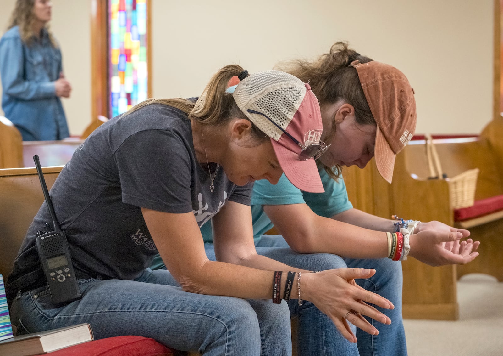 Ginger Turner, and her daughter, Hailey, right, pray during church services held at the Hunt Baptist Church on Sunday, July 6, 2025, in Hunt, Texas. Their small town sits on the bank of the Guadalupe River and was severely damaged by recent flooding. (AP Photo/Rodolfo Gonzalez)