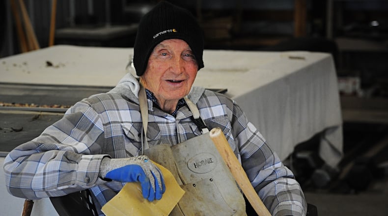 Retired 93-year-old Air Force Col. John Hobson, shown in the workshop Thursday, Dec. 10, 2020, where he lives with his son's family near Xenia, handcrafts walking sticks that he sells for $3 each to benefit the Xenia FISH Food Pantry. MARSHALL GORBY/STAFF