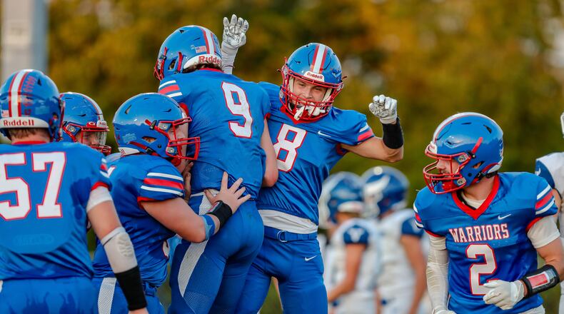 Northwestern High School juniors Luke Fissel (8) and Ried Smith (9) celebrate after a big play during their game against Miami East earlier this season at Taylor Field in Springfield. CONTRIBUTED PHOTO BY MICHAEL COOPER