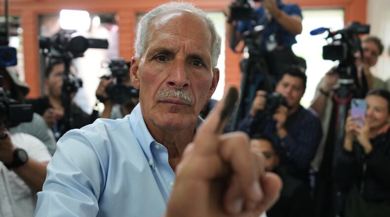 Nasry Asfura, presidential candidate for the National Party, shows his inked finger afterv voting in general elections in Tegucigalpa, Honduras, Sunday, Nov. 30, 2025. (AP Photo/Moises Castillo)