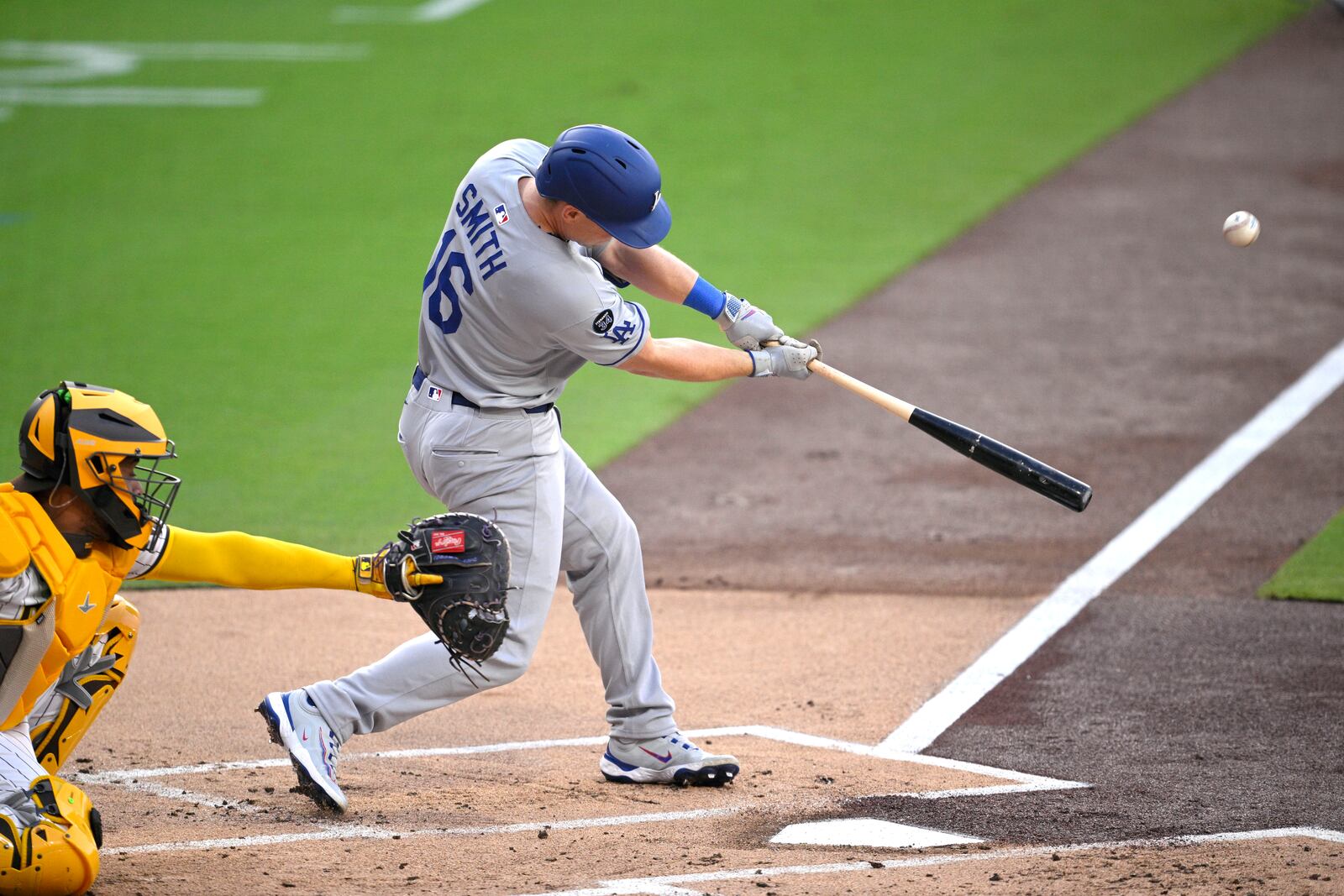 Los Angeles Dodgers' Will Smith (16) hits a sacrifice fly against the San Diego Padres during the first inning of a baseball game Monday, June 9, 2025, in San Diego. (AP Photo/Orlando Ramirez)
