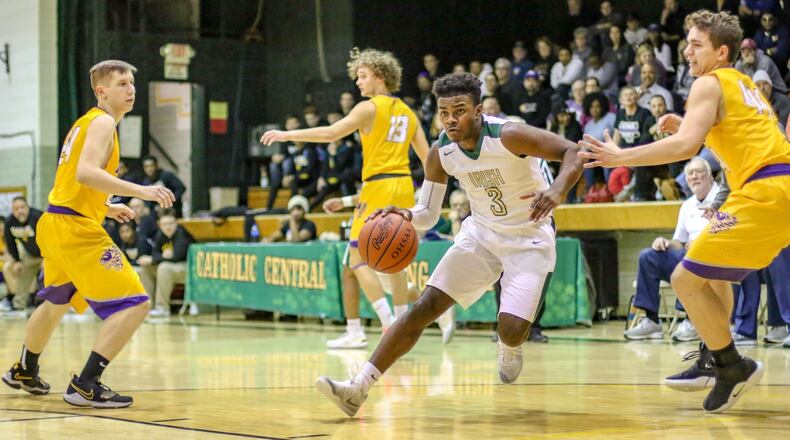 Catholic Central’s Jayden Borden drives past Emmanuel Christian’s Seth Potts during their game on Tuesday night at Jason Collier Gymnasium in Springfield. The Irish won 62-47. CONTRIBUTED PHOTO BY MICHAEL COOPER