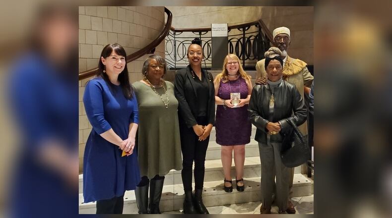 Springfield Museum of Art executive director Jessimi Jones, left, collections and exhibitions manager Elizabeth Wetterstroem, center with award, and Willis "Bing" Davis, right, were present to accept the Ohio Museums Association's Best Exhibit Award for its "Black Life as Subject Matter II" exhibition.