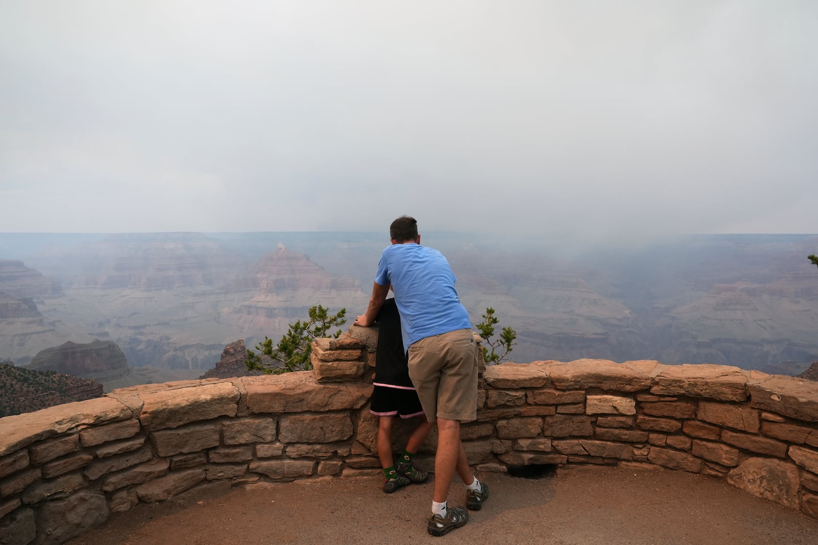 Smoke from the Dragon Bravo Fire moves over the Grand Canyon from the North Rim, Monday, July 14, 2025, in Grand Canyon National Park, Ariz. (AP Photo/Ross D. Franklin)