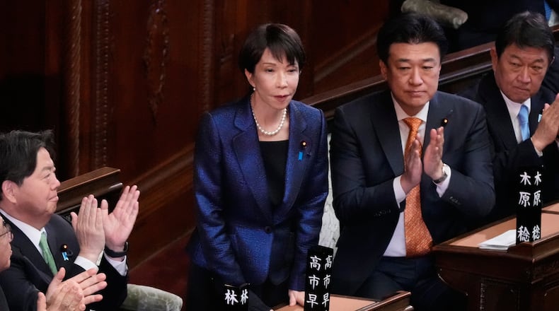 Japanese Prime Minister Sanae Takaichi, center, is applauded by members of the lower house of Japan's parliament as Takaichi was reelected as prime minister during a special session in Tokyo, Japan, Wednesday, Feb. 18, 2026. (AP Photo/Eugene Hoshiko)