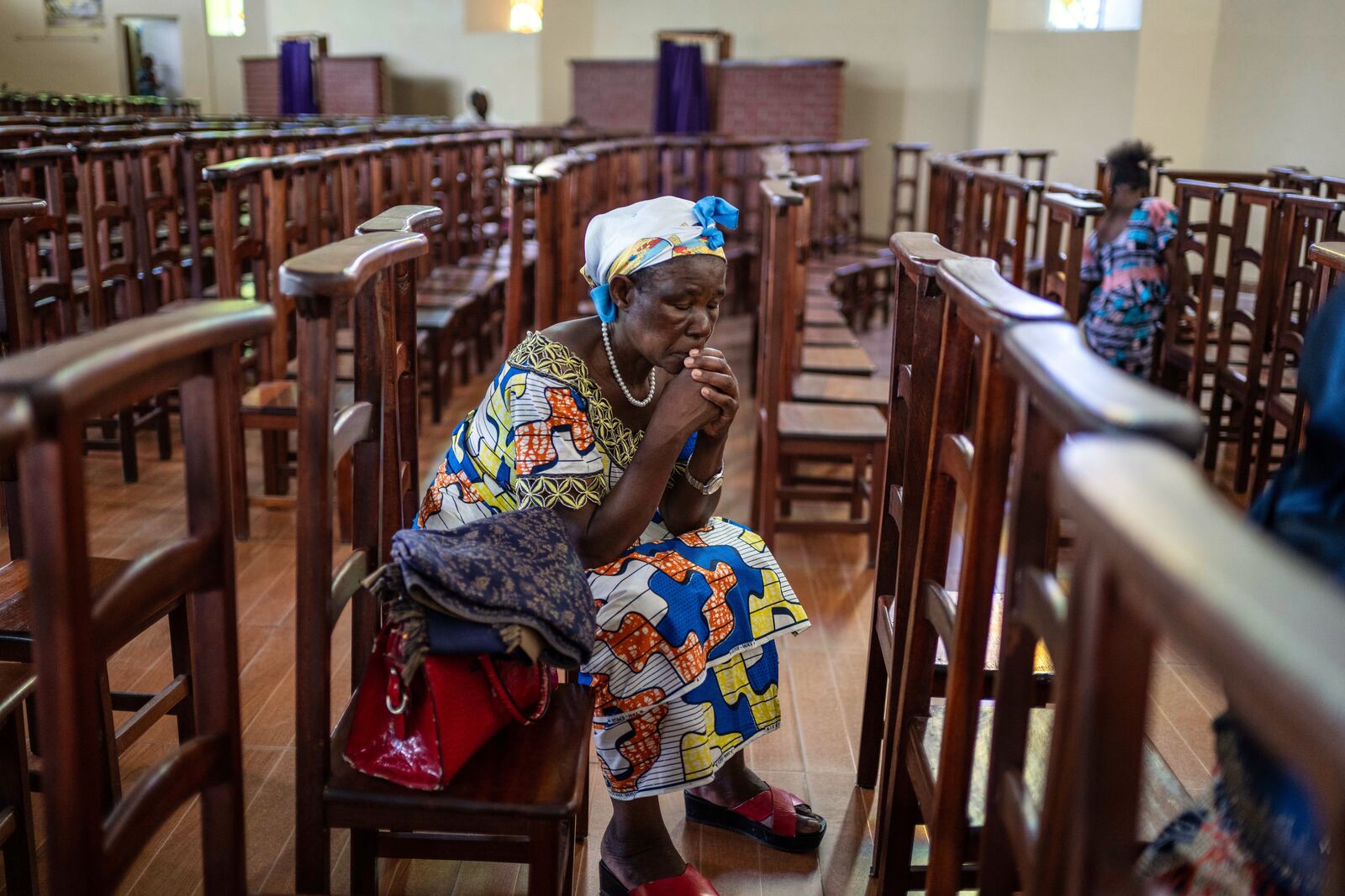 A woman prays during the morning mass at the Sanctuaire d'adoration cathedral, following the announcement of Pope Francis's death in Goma, Democratic Republic of Congo, Monday, April 21, 2025. (AP Photo/Moses Sawasawa)