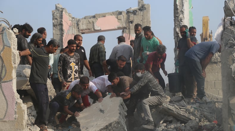Rescue workers and residents search through the rubble in the aftermath of a strike on a girls' elementary school in Minab, Iran, Saturday, Feb. 28, 2026. (Abbas Zakeri/Mehr News Agency via AP)