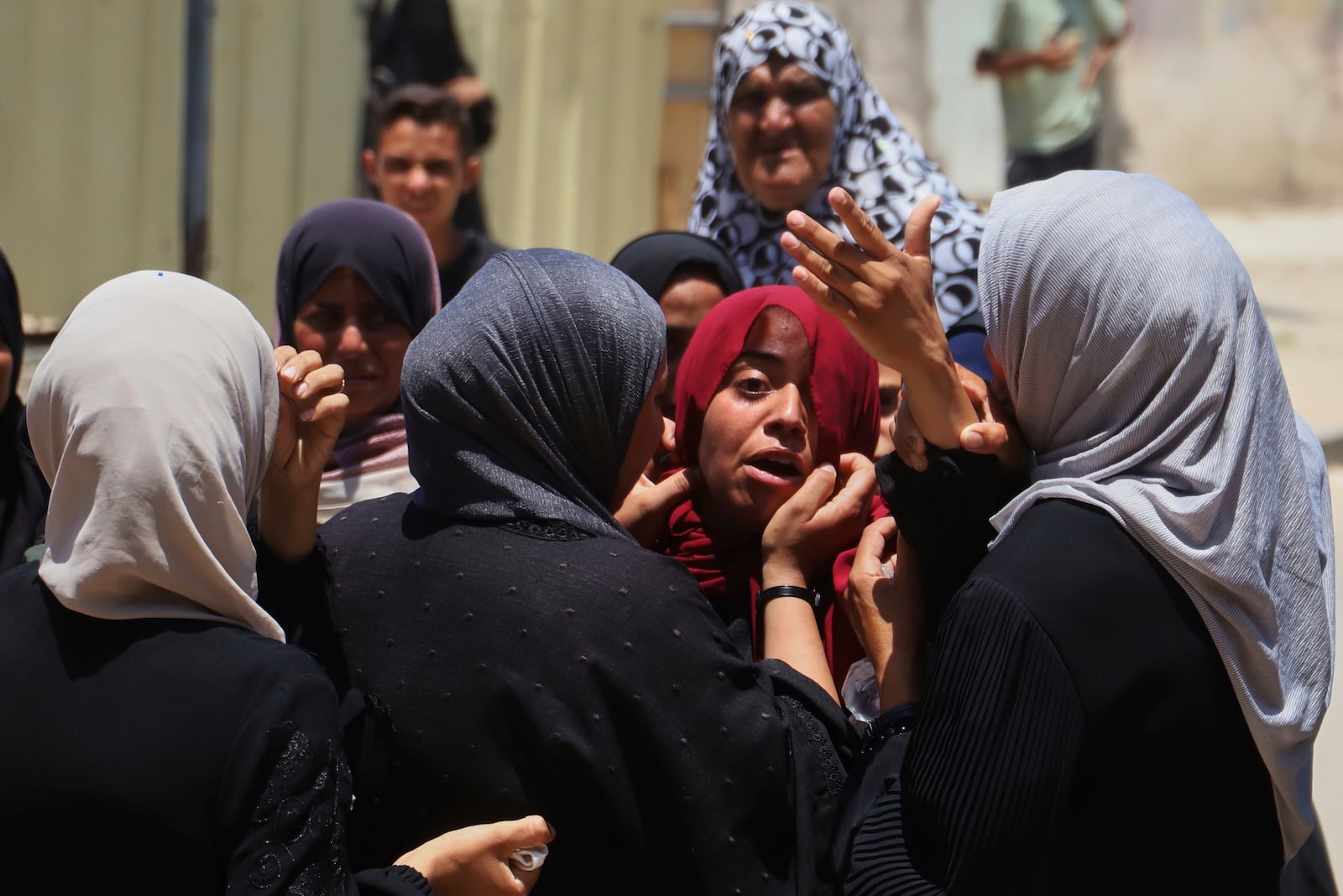Palestinians women mourn during the funeral of people who were killed while returning from one of the Gaza Humanitarian Foundation distribution centers operated by the U.S.-backed organization, according to Nasser Hospital, during their funerals in Khan Younis, Monday, June 30, 2025. (AP Photo/Mariam Dagga)