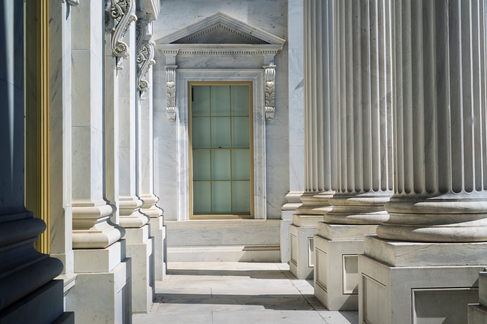 Early morning light filters through the fluted columns of the House of Representatives as lawmakers await final passage of President Donald Trump's signature bill of tax breaks and spending cuts, at the Capitol in Washington, Thursday, July 3, 2025. (AP Photo/J. Scott Applewhite)