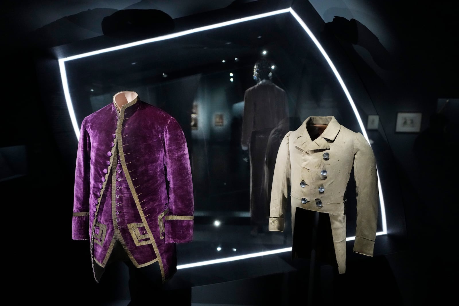 A livery coat and waistcoat worn by and enslaved servant, left, and a Brooks Brothers coat worn by an enslaved child are displayed at the Metropolitan Museum of Art's Costume Institute exhibition, "Superfine: Tailoring Black Style," on Saturday, May 3, 2025, in New York. (Photo by Charles Sykes/Invision/AP)