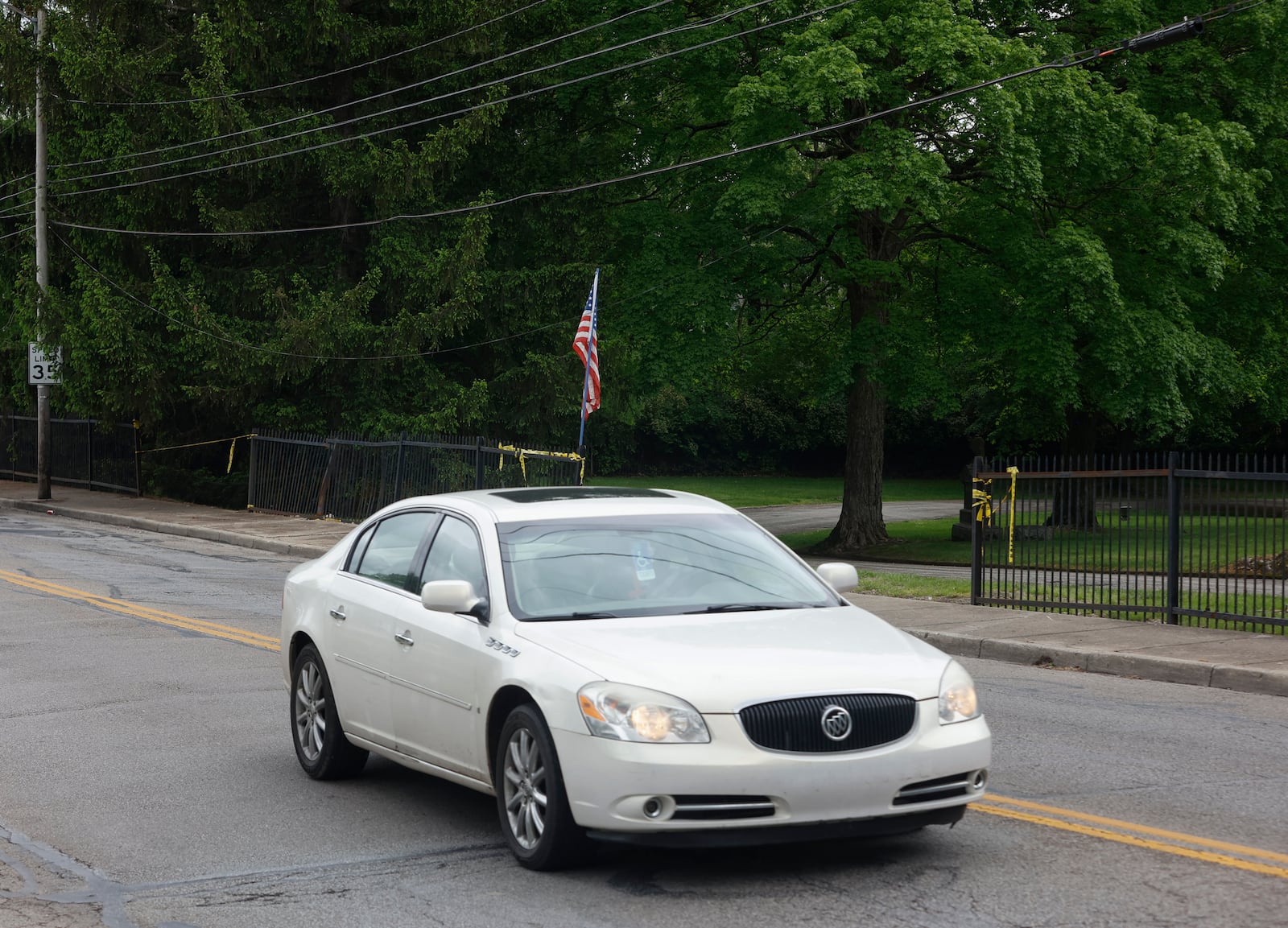 A car travels on McCreight Avenue on Tuesday, May 13, 2025, outside Ferncliff Cemetery. The fence has been hit by cars 65 times since 2018 and cemetery workers have advocated for changes to stop the accidents. JOSEPH COOKE/STAFF

