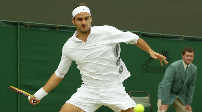 FILE - Switzerland's Roger Federer plays a return to Sjeng Schalken, of the Netherlands, during their men's singles quarter final match at the All England Lawn Tennis Championships at Wimbledon, July 3, 2003. (AP Photo/Alastair Grant, File)