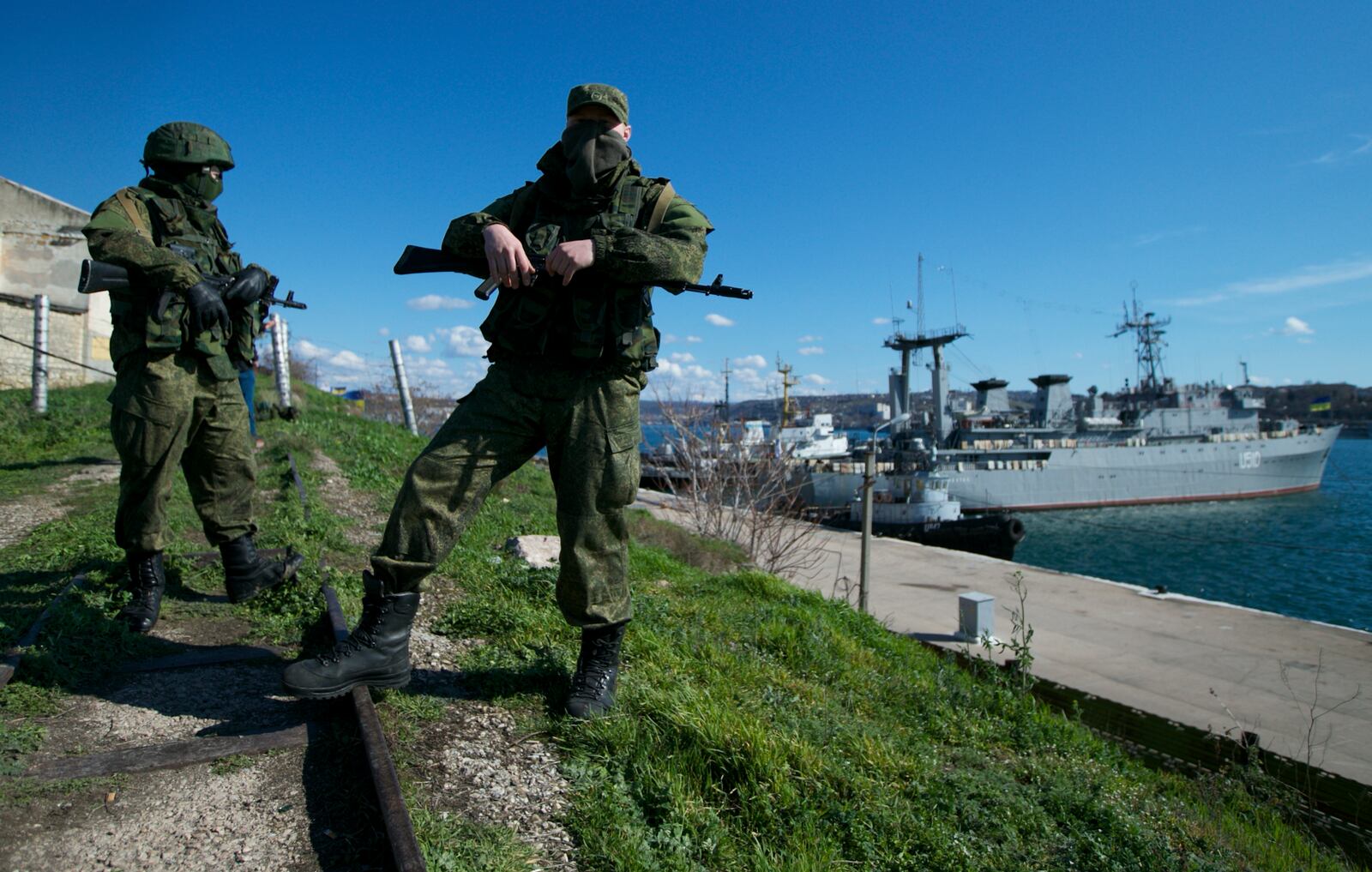 FILE - Russian soldiers guard a pier where two Ukrainian naval vessels are moored, in Sevastopol, on the Crimean Peninsula, March 5, 2014. (AP Photo, File)