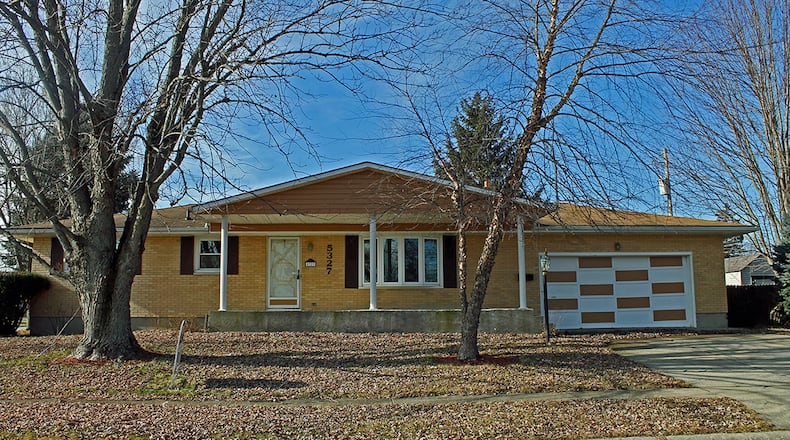 This 4-bedroom, brick ranch has about 1,125 sq. ft. of living space with a full, finished basement. The home includes an attached, 2-car garage and an in-ground pool. CONTRIBUTED PHOTO BY VICKIE KAPNAS