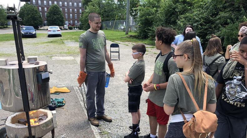 University of Dayton assistant professor Geno Luketic instructs students in the Japanese technique of Raku to create ceramics using a kiln at Project Jericho’s annual Summer Arts Camp on Friday. Photo by Brett Turner