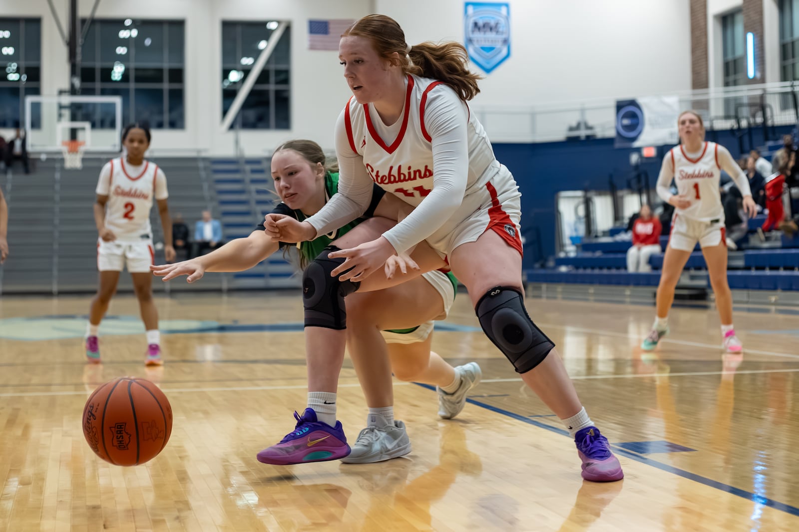 Stebbins High School senior Abigail Neria and Northmont sophomore Sophie Secor dive for a loose ball during their Division II district semifinal game on Wednesday, Feb. 25, 2026 at Fairborn's Skyhawk Arena. The Indians won 52-42. MICHAEL COOPER / STAFF