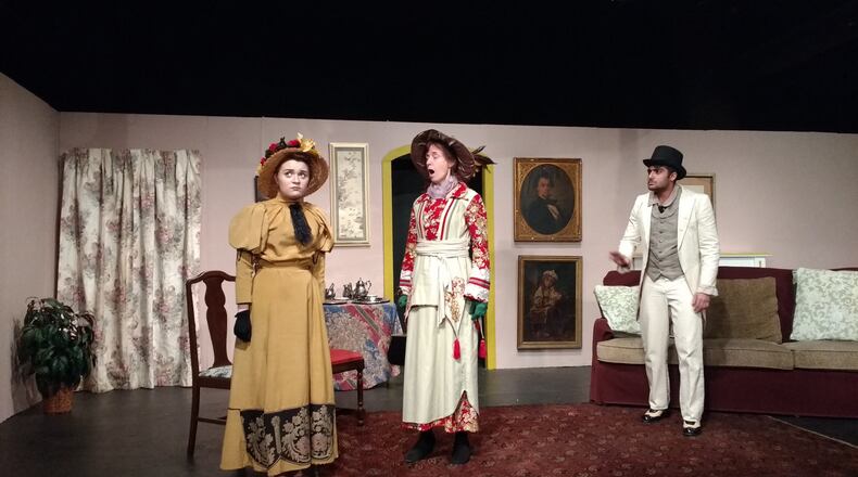 Kylee Pauley, Kathleen Day and Anand Sharma rehearse a scene from the Xenia Area Community Theater’s production of Oscar Wilde’s classic satire, “The Importance of Being Earnest,” directed by Springfield resident Connie Strait. CONNIE STRAIT/CONTRIBUTED