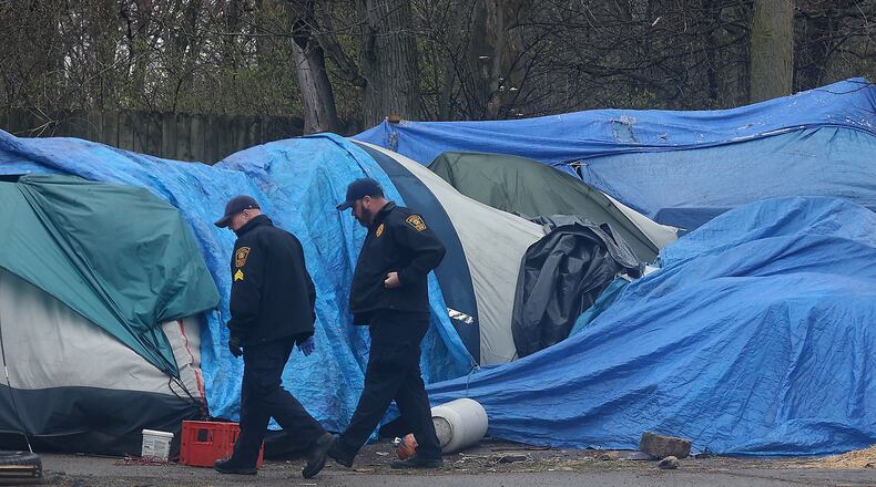 Springfield police investigate a homicide at a homeless encampment at 901 West Main Street Wednesday, April 6, 2022. BILL LACKEY/STAFF