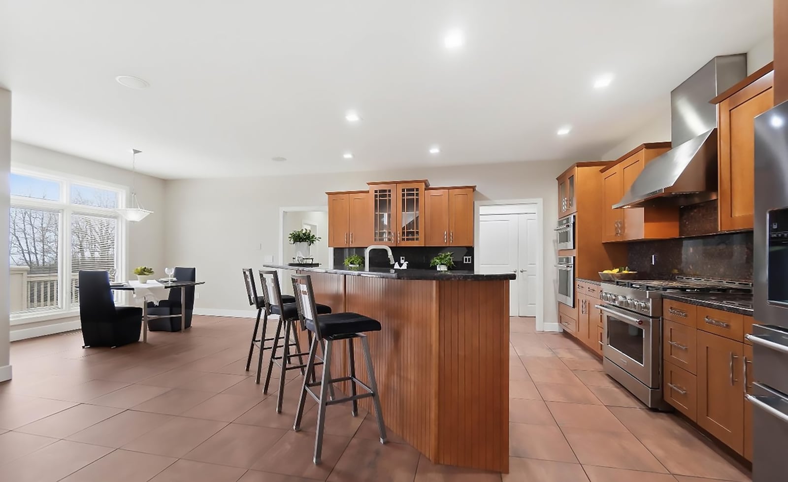 The eat in kitchen has tile flooring, custom wood cabinets and professional style appliances including a gas range and wall ovens. There is also an island with bar seating. CONTRIBUTED