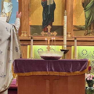 With a koliva at his side, Father Dumitru Rusu conducts a memorial service at Springfield’s Assumption Church of the Blessed Virgin (Greek) Orthodox Church. Anna Plataniotis/Contributor