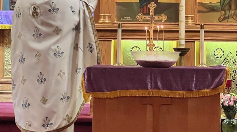 With a koliva at his side, Father Dumitru Rusu conducts a memorial service at Springfield’s Assumption Church of the Blessed Virgin (Greek) Orthodox Church. Anna Plataniotis/Contributor