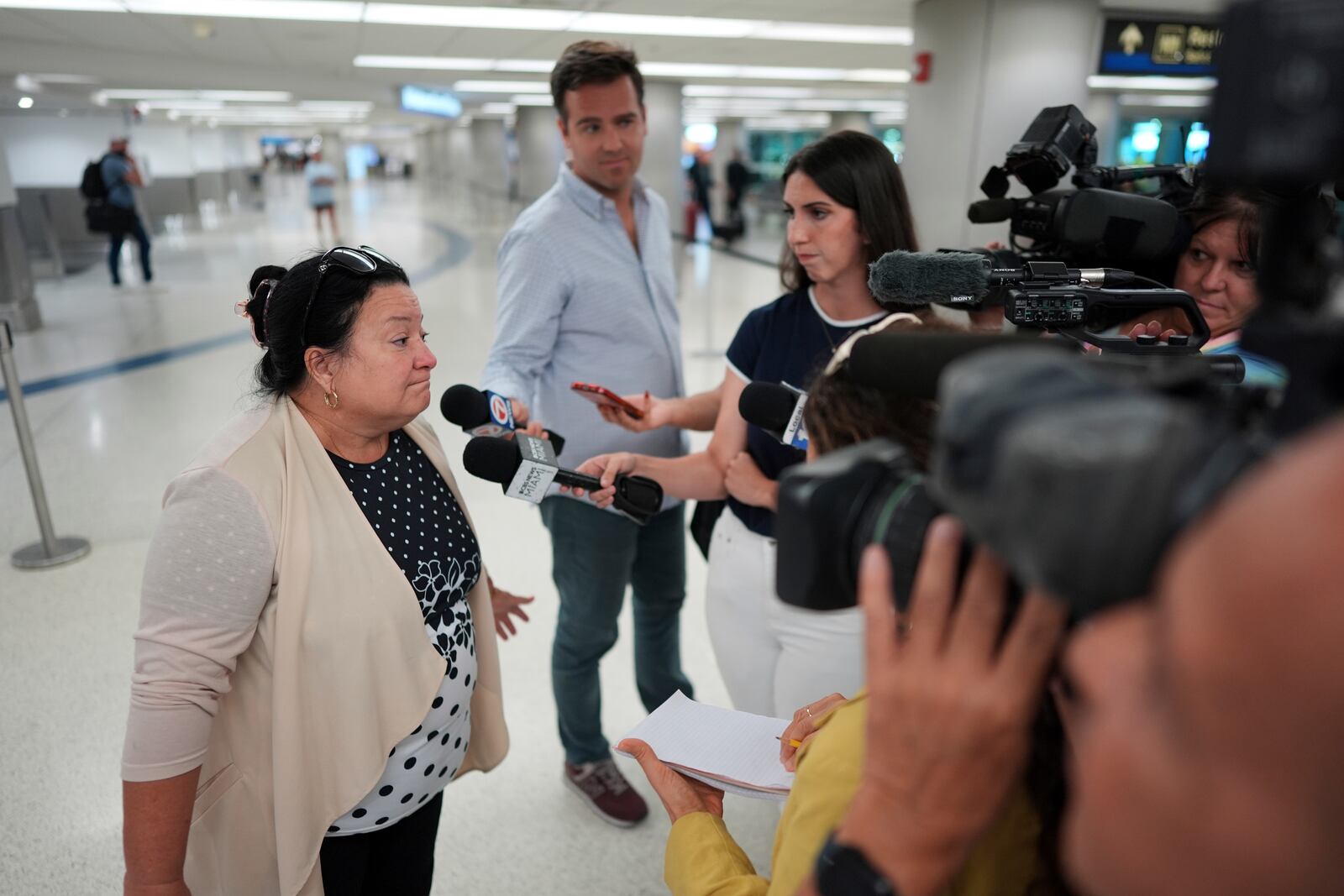 Magda Moreno, 58, a Cuban-American who had just arrived back from Havana, speaks to journalists at Miami International Airport, Monday, June 9, 2025, in Miami. (AP Photo/Rebecca Blackwell)