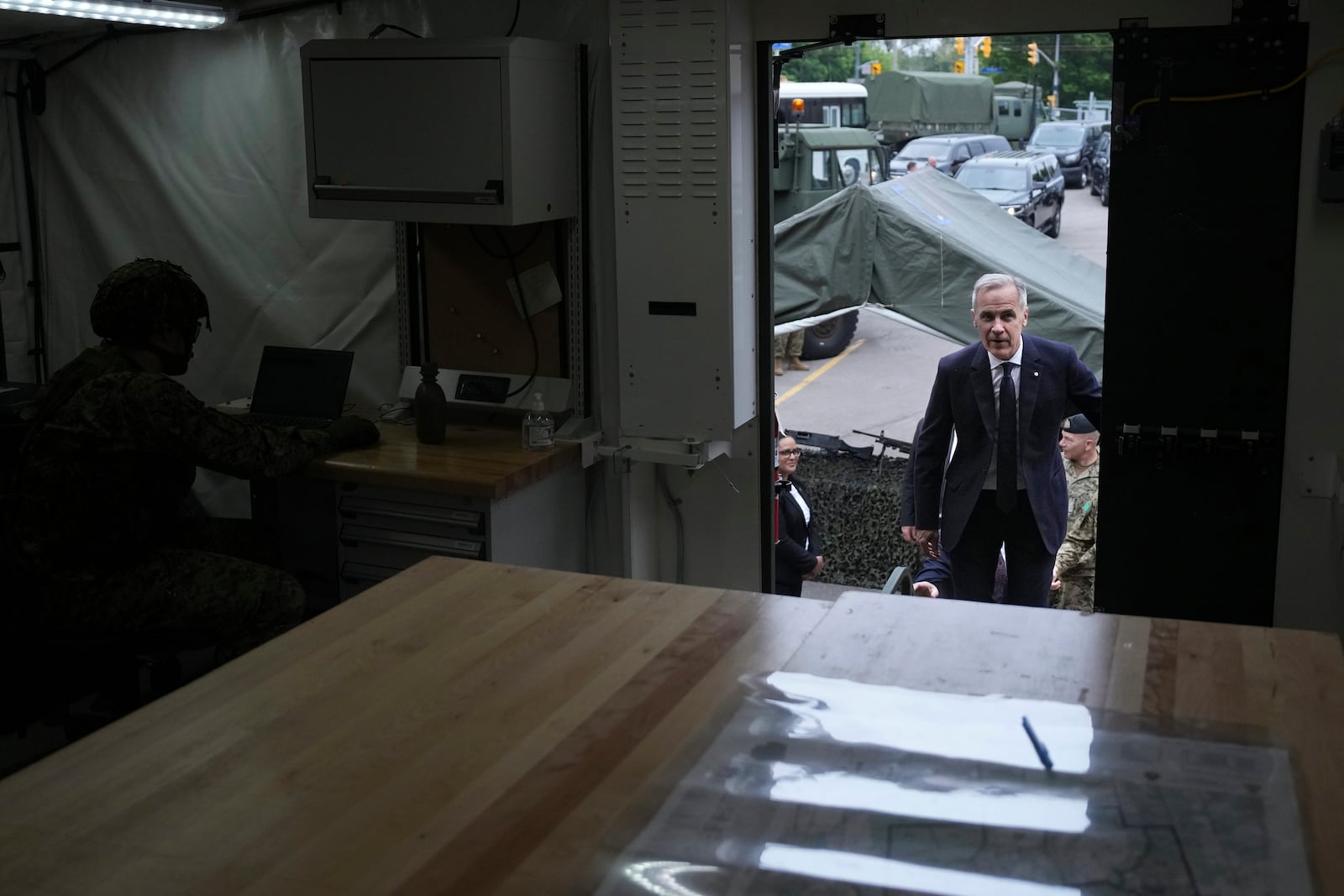 Canada Prime Minister Mark Carney steps into a command post as he visits Fort York Armoury in Toronto, Canada, before making an announcement on Monday, June 9, 2025. (Chris Young/The Canadian Press via AP)