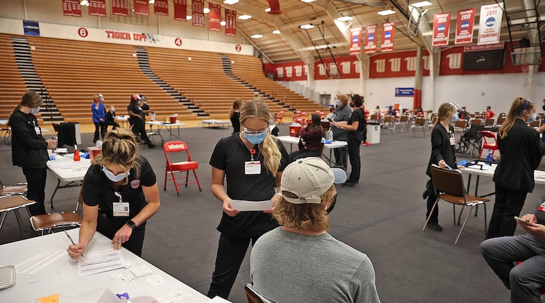A COVID vaccination clinic is set up in the Pam Evans Smith Arena at Wittenberg University to vaccinate the Wittenberg students. BILL LACKEY/STAFF