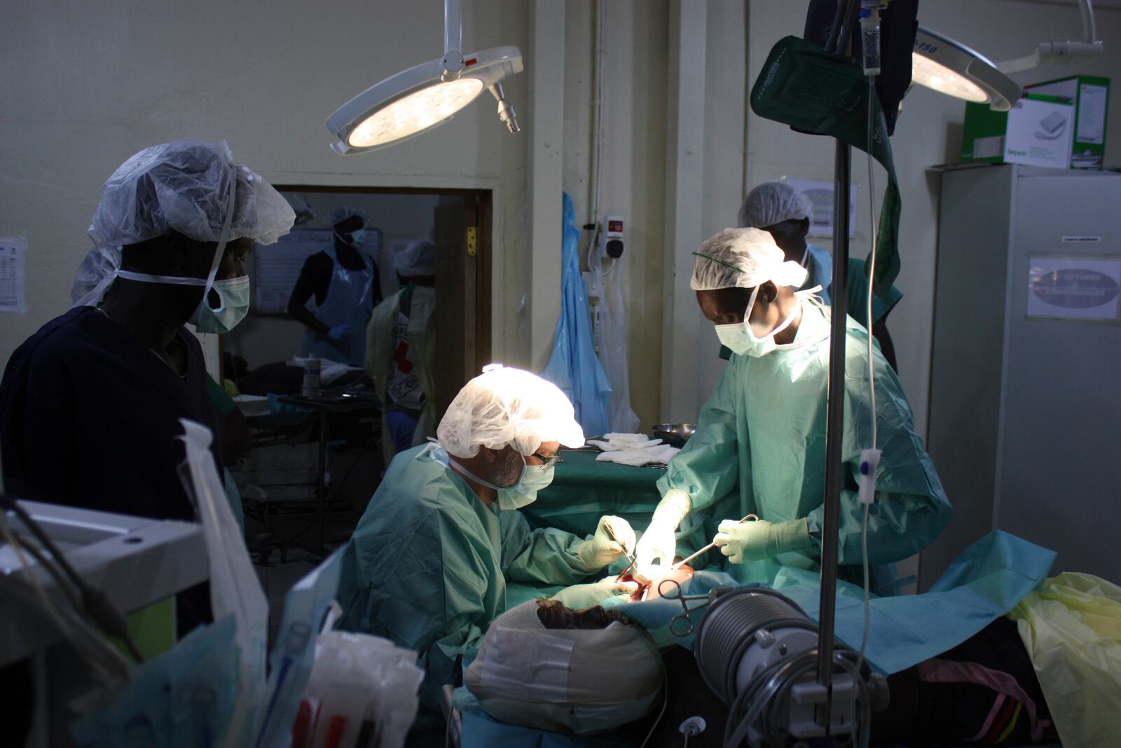 International Committee of the Red Cross doctors (ICRC), operates on a man wounded by an airstrike at a field hospital in Akobo, South Sudan, Friday, May 23, 2025. (AP Photo/Joseph Falzetta)