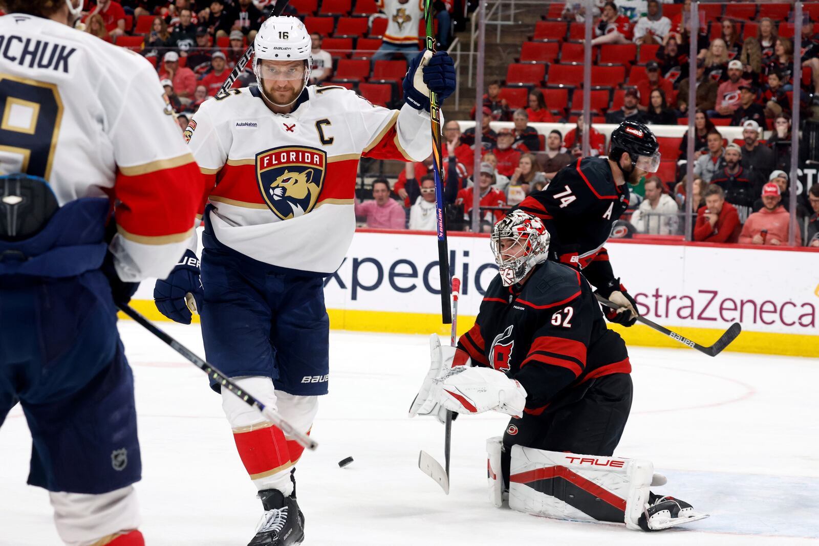 Florida Panthers' Aleksander Barkov, right, celebrates his goal with Florida Panthers' Matthew Tkachuk (19) as Carolina Hurricanes goaltender Pyotr Kochetkov (52) looks on during the third period of Game 2 of the NHL hockey Stanley Cup Eastern Conference finals in Raleigh, N.C., Thursday, May 22, 2025. (AP Photo/Karl DeBlaker)